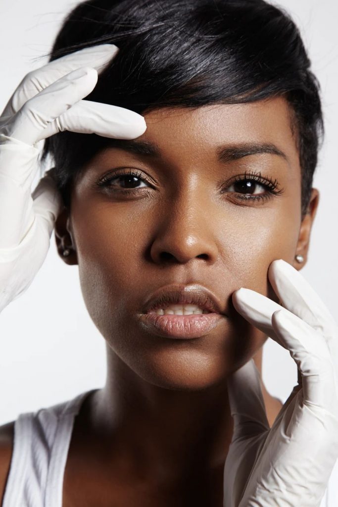 Black woman with white gloves