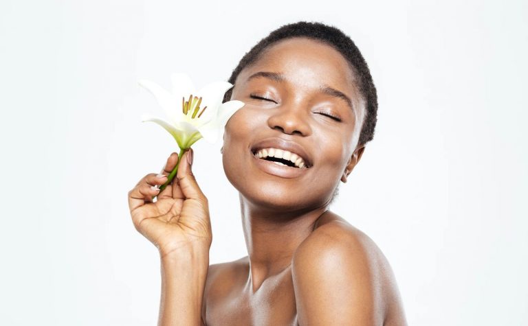 Woman with black skin holding a flower